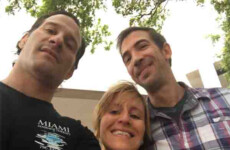 Three people taking a group selfie outdoors, with trees and a building in the background. Three people taking a group selfie outdoors, with trees and a building in the background.